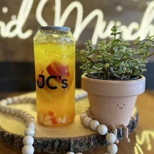 a jar of iced tea and a potted plant
