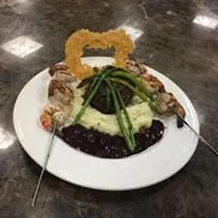 Delicious filet w/ red wine reduction, grilled shrimp, Parmesan crisp, mashed potatoes and asparagus!
