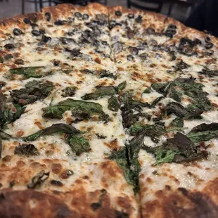 4 Cheese Manhattan Pizza with spinach black olives and basil