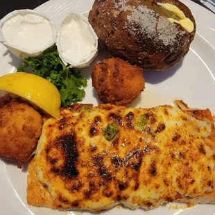 Parmesan Encrusted Salmon, baked potato, and hush puppies.