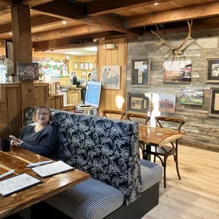 a woman sitting at a table in a restaurant