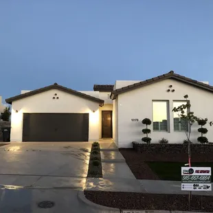 the front of a house with a for sale sign in front of it