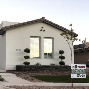 a house with a for sale sign in front of it