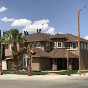 a house with palm trees in front of it
