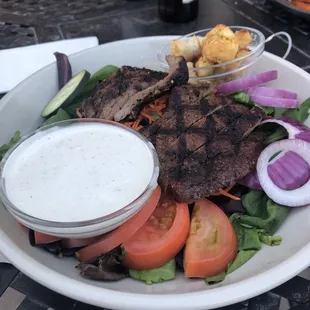 Steak salad.... Great portion size. We loved the outdoor seating.. Great service... Excellent cocktails. Great home town vibe.