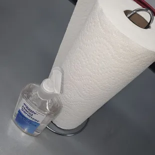 a roll of toilet paper and a bottle of hand sanitizer