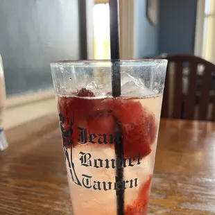 a drink with strawberries in a glass