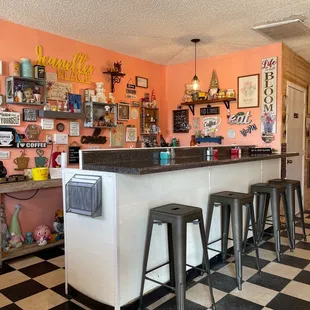 a bar with stools and a checkered floor