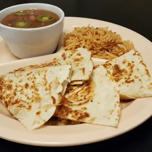 a plate of quesadillas and a bowl of soup