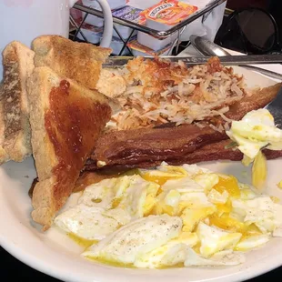 Eggs toast bacon and hash browns