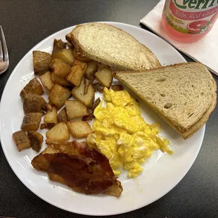 Bacon, scrambled eggs, home fries, and rye toast.