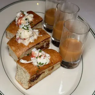 a plate of sandwiches and a glass of orange juice