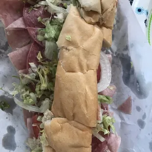 a sub sandwich with meat and lettuce