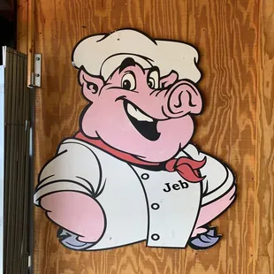 a pig in a chef&apos;s uniform