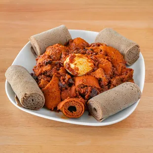 Quanta Fir Fir 
(jerky meat + tomatoes + onions + hard cooked eggs with ethiopian butter and spices