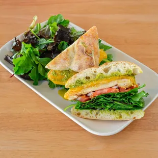 Chicken with pesto Sandwich 
(grilled chicken + lettuce + tomato + red onion + cheddar jack cheese + pesto on ciabatta served with salad)