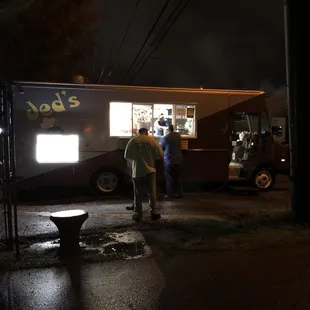 a man standing in front of a food truck