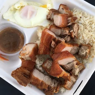 Kawalisilog: Fried pork belly, garlic rice, over easy egg, atchara, mang tomas sauce | $9 + $4 extra meat