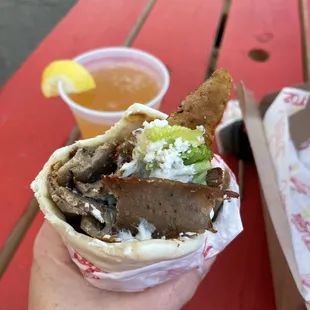 a hand holding a burrito