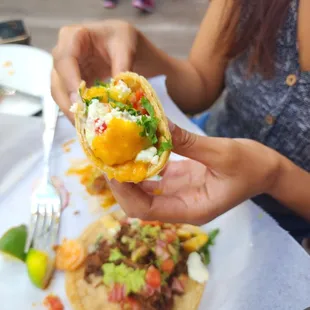 a person holding a taco