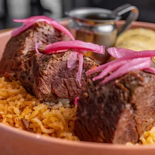 Our new Birria Rib platter: Birria ontop of spanish rice, refried beans, tortillas, consome