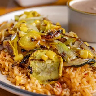 Calabacitas, our vegetarian dish with rice and sauteed veggies with refried beans