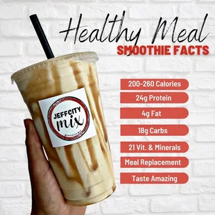 a hand holding a smoothie