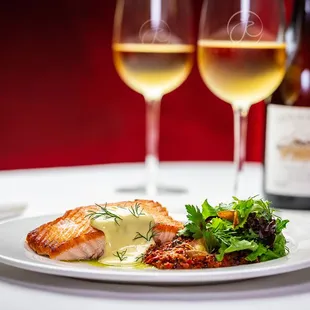 two glasses of wine and a plate of food