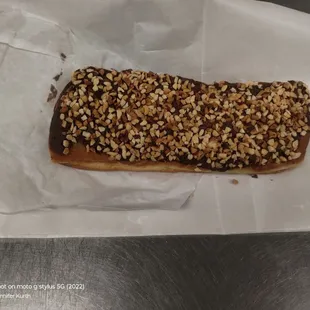 Chxollate frosted donut with crushed peanuts