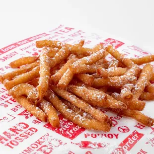 a close up of a pile of fried donuts