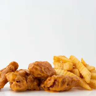 a pile of fried chicken and french fries