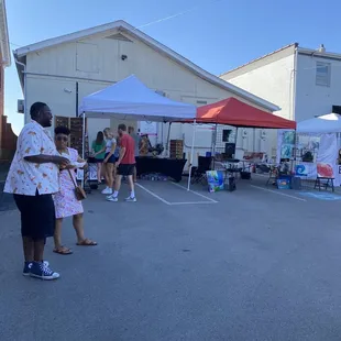 people standing under tents