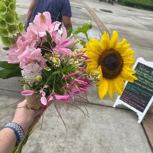 a person holding a bouquet of flowers
