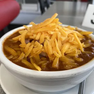 chili topped with cheddar queso