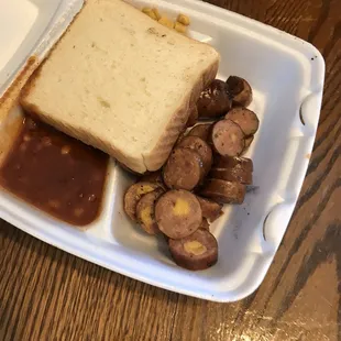Jalapeño sausage plate with bbq beans and creamed corn (under the bread slice)