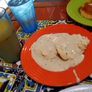 Simple biscuit with nicely peppered white gravy and orange juice