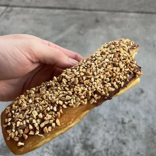 Chocolate long John topped with Peanuts