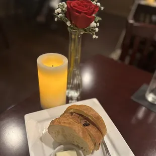 a glass of orange juice and a piece of bread