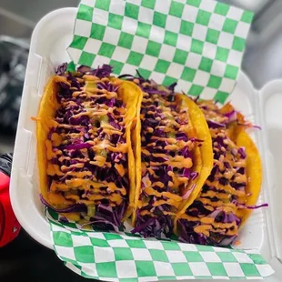 three tacos in a styrofoam container