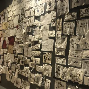 a wall covered with drawings