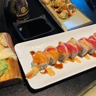 a plate of sushi and a bottle of beer