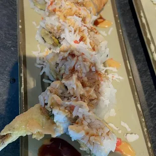 two plates of sushi with sauce