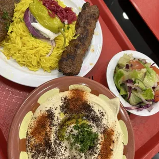 Beef kebab plate with salad and hummus