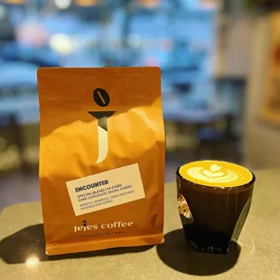 Our in-house, freshly roasted coffee beans and cortado.