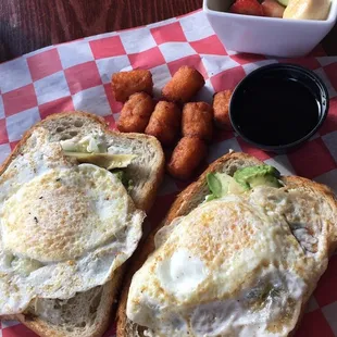 Goat cheese avocado toast with sweet potato tots and fruit salad.