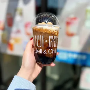 a person holding a cup of coffee