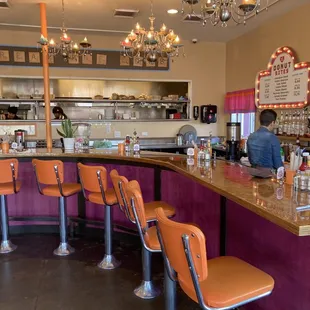 a man sitting at a counter in a diner