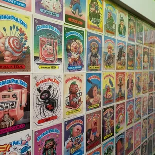 Men&apos;s bathroom wallpapered in Garbage Pail Kids cards. Pretty awesome.