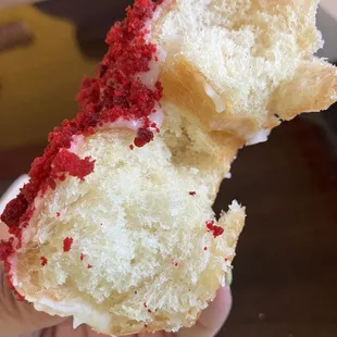 a hand holding a piece of cake
