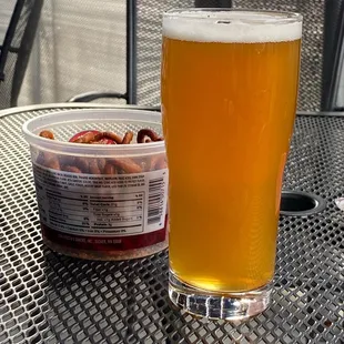 a glass of beer and a container of jellyfish